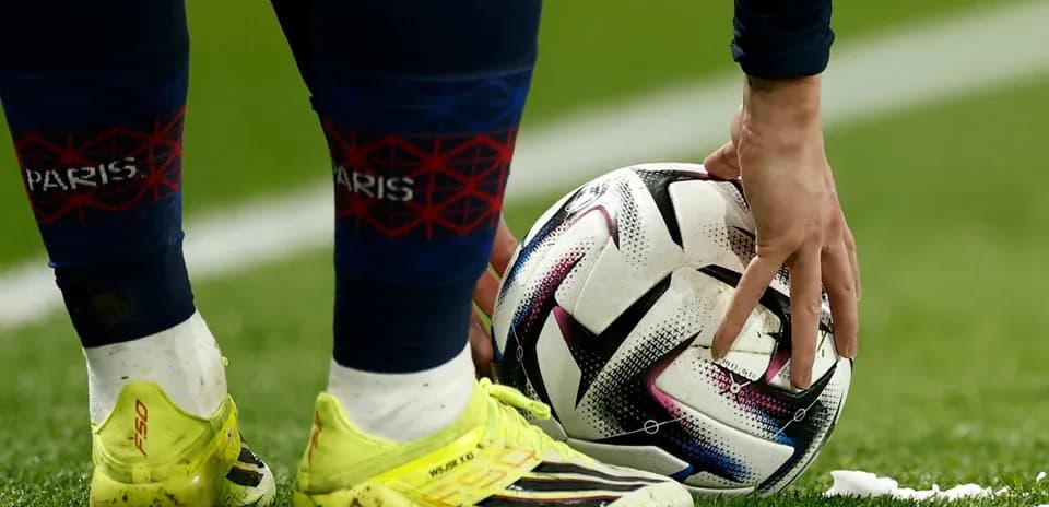Player placing ball on pitch during match