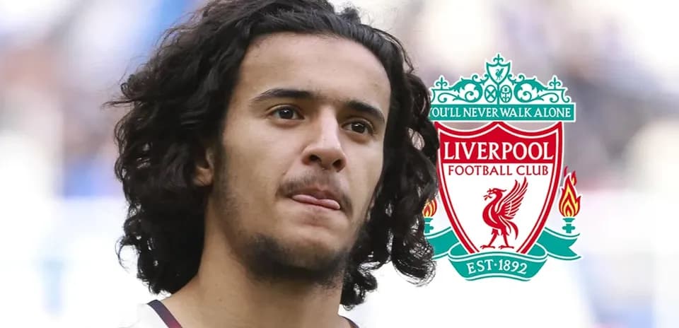 Player with curly hair and Liverpool FC logo
