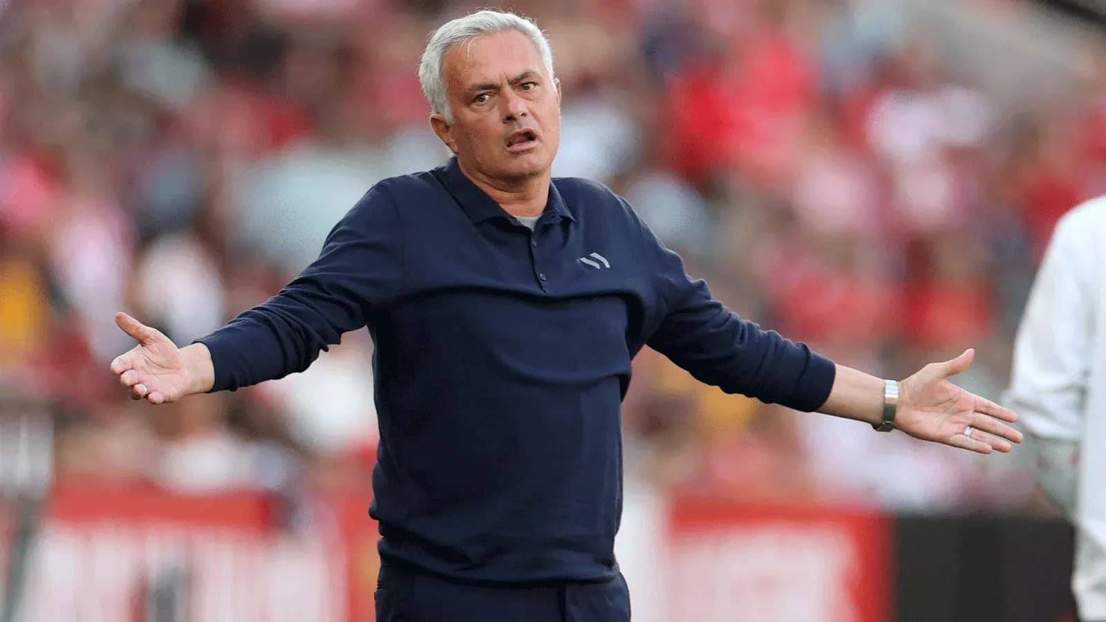 Coach gesturing during a match on the sideline