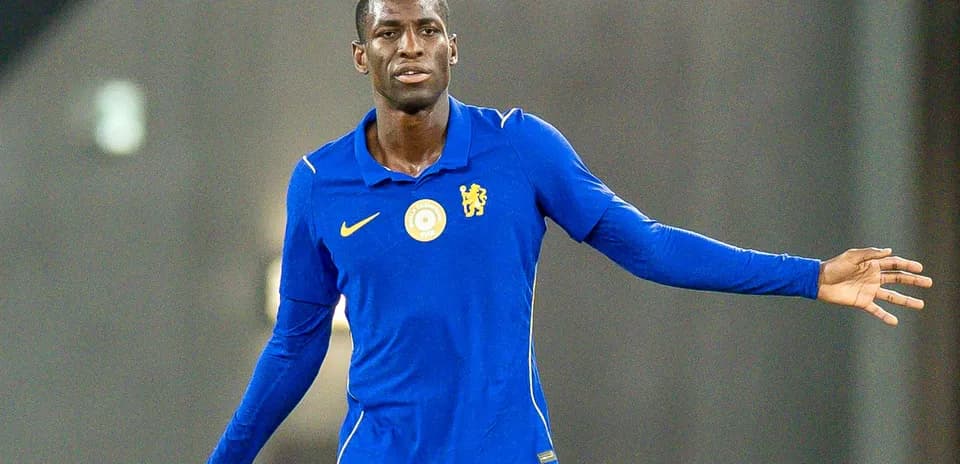 Player in blue kit gesturing during training session