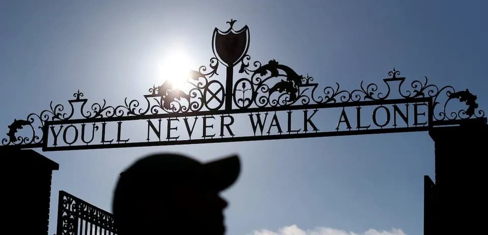 Sign reading 'YOU'LL NEVER WALK ALONE' at stadium entrance