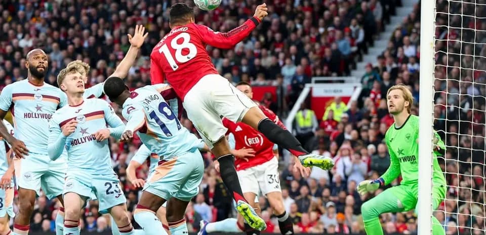 Manchester United player attempting a header