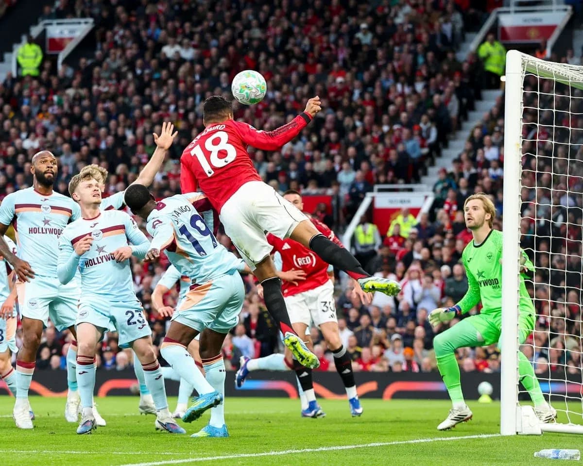 Manchester United player attempting a header