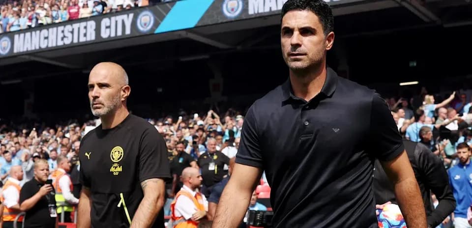 Two coaches walking on the pitch before match