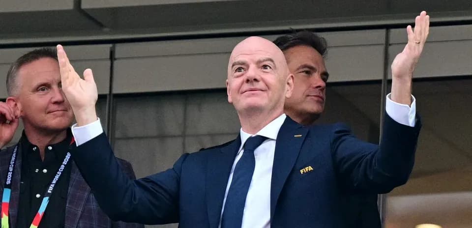 FIFA president gesturing from VIP box during event