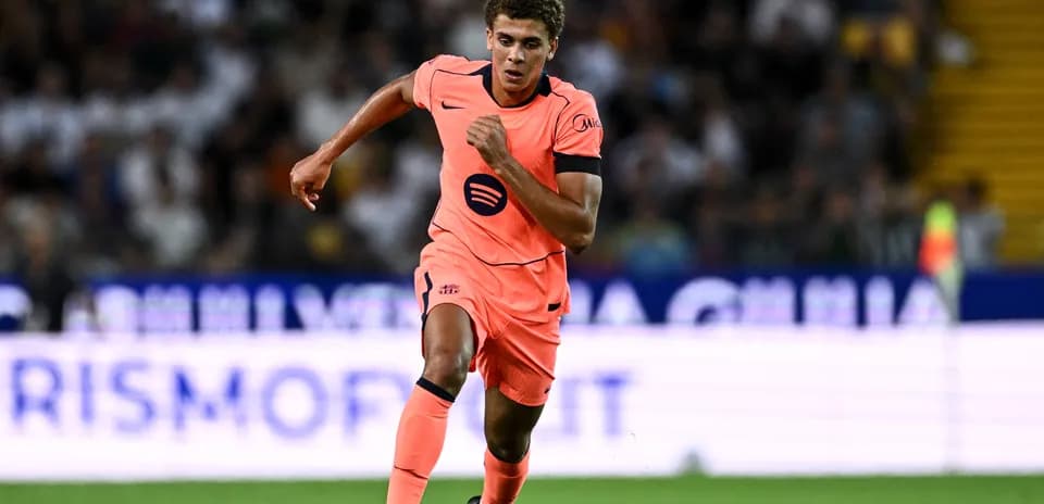 Player in pink kit running during match
