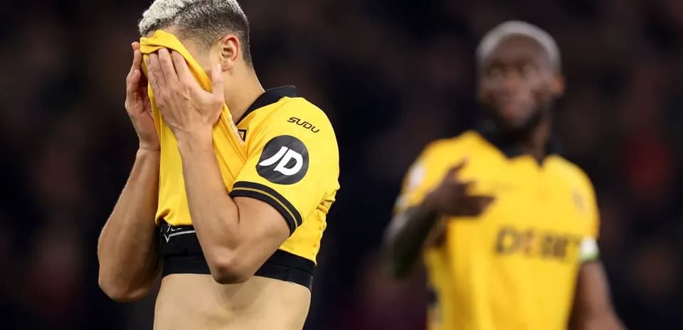 Player covering face with shirt after match