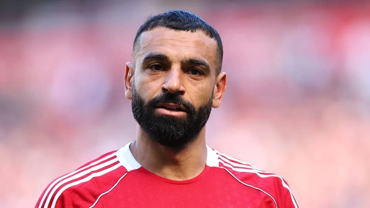 Player wearing red jersey during match warm-up