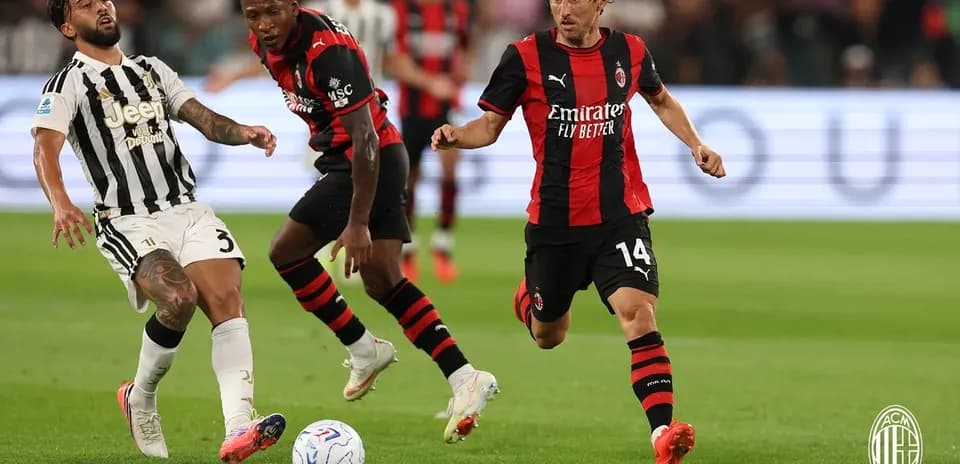 Juventus player challenged by AC Milan opponents