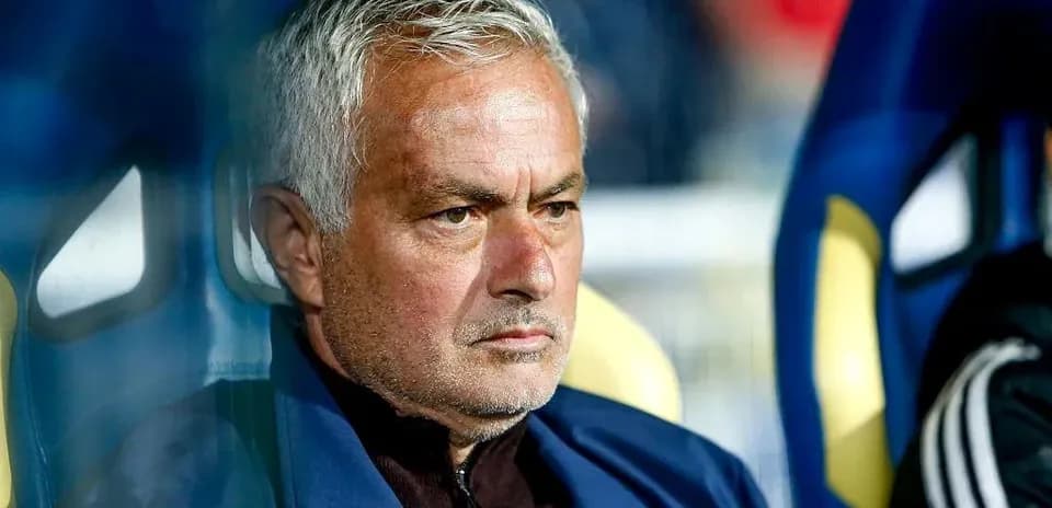 Manager sitting on the bench during a match