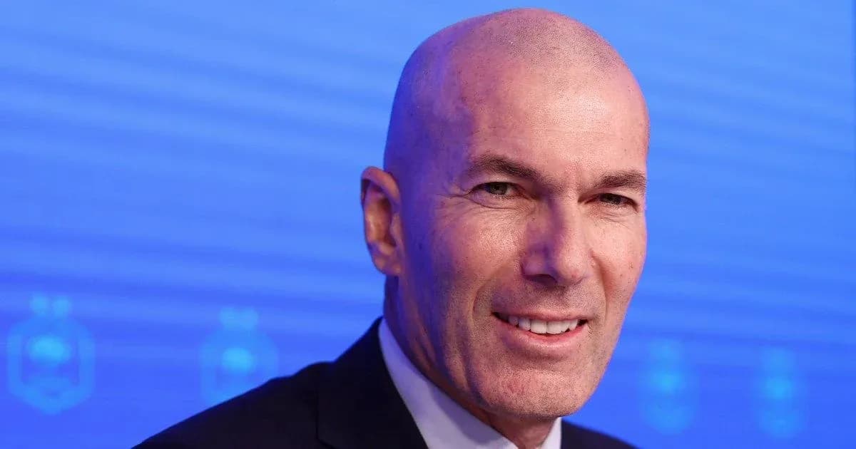 Man smiling at a press conference backdrop