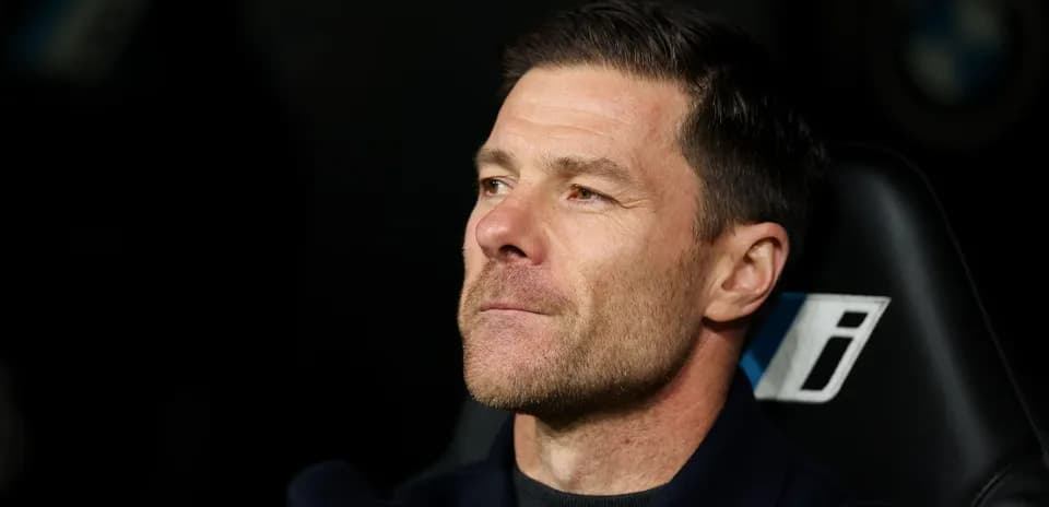 Coach seated on bench during match
