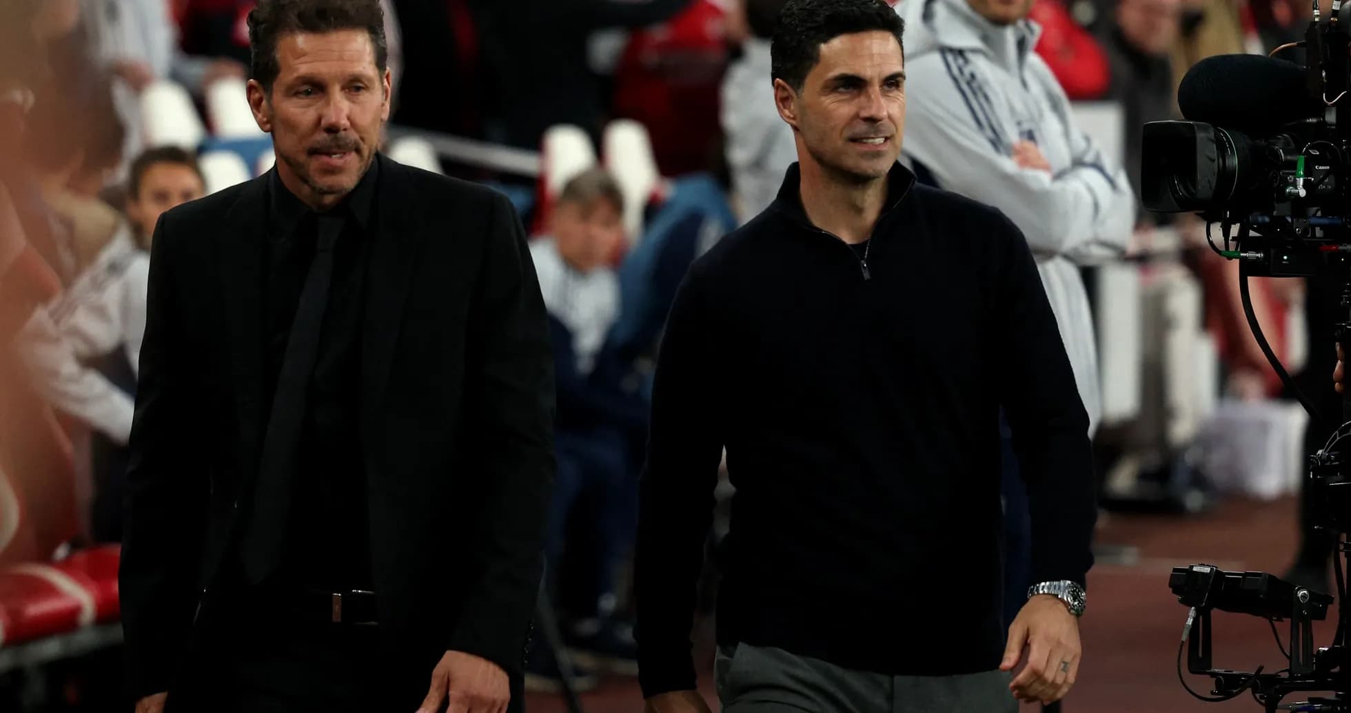 Two football managers walking on the pitch