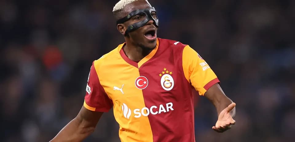 Player celebrating in Galatasaray jersey with mask