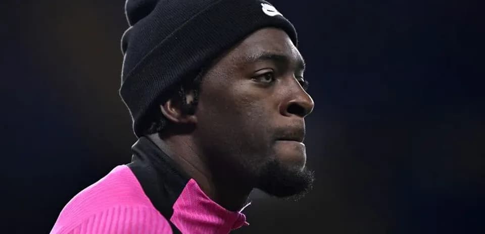 Player in pink warm-up gear during match preparation