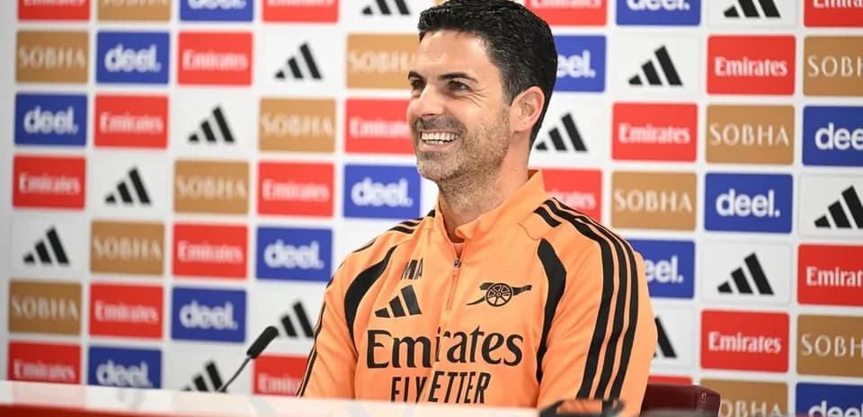 Manager at press conference with sponsor backdrop