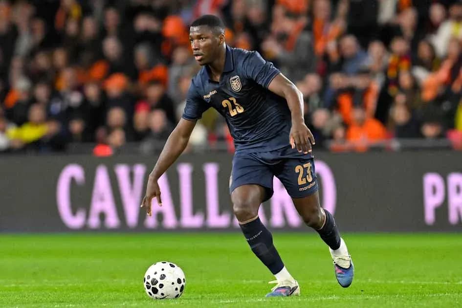 Player wearing blue kit dribbling ball during match
