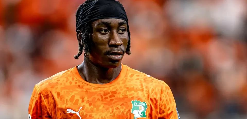 Goalkeeper in orange jersey during match preparation