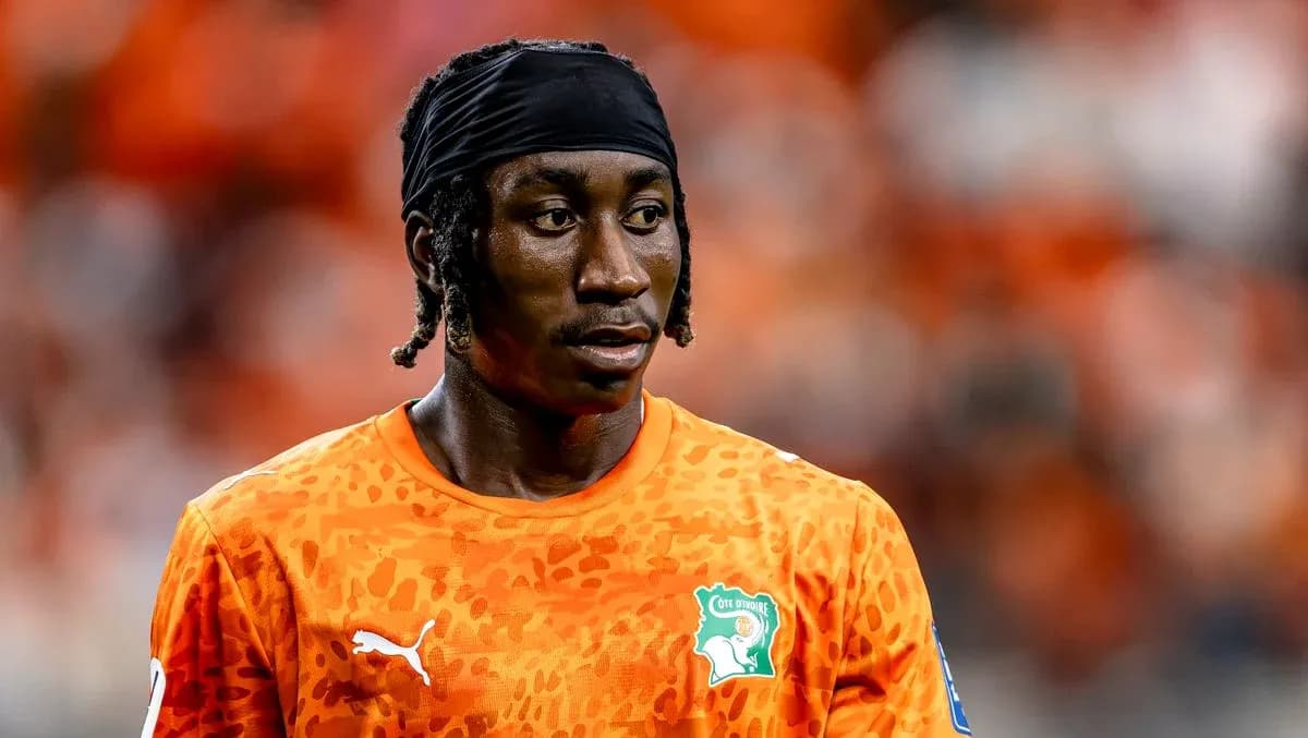 Goalkeeper in orange jersey during match preparation