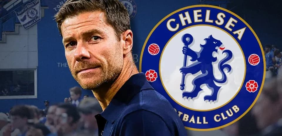Coach in front of Chelsea FC logo and fans