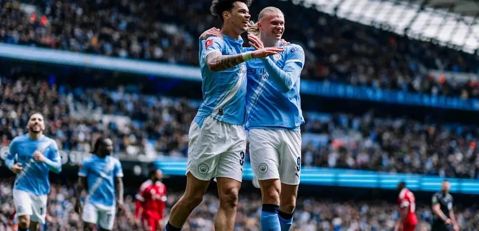 Manchester City players celebrating a goal together