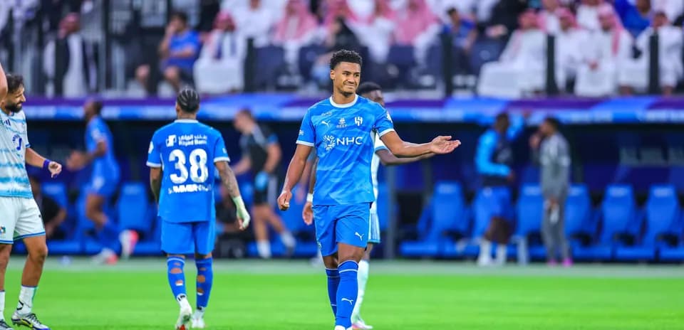 Player gesturing during match with teammates in background