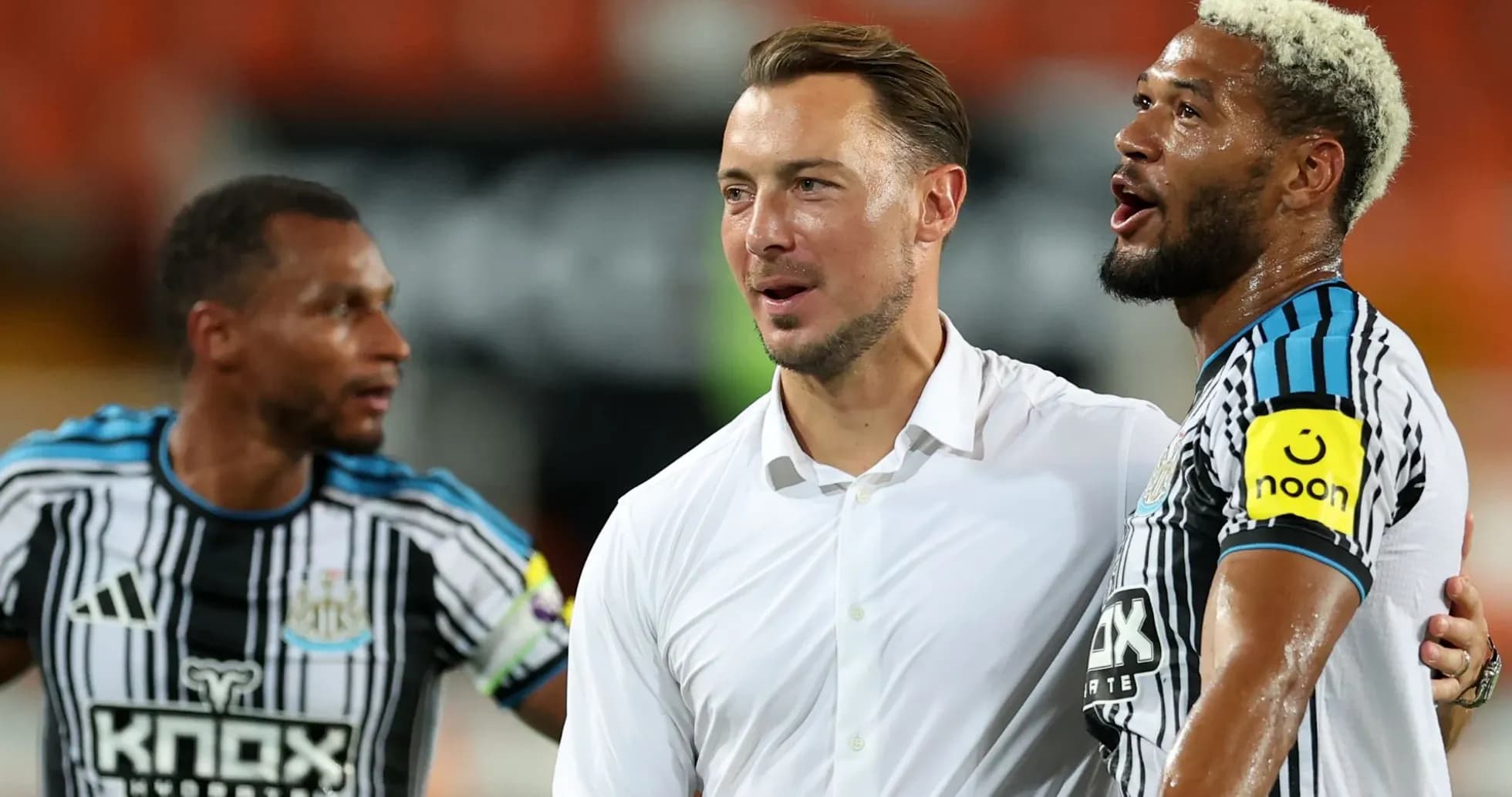 Newcastle players celebrating with coach after match