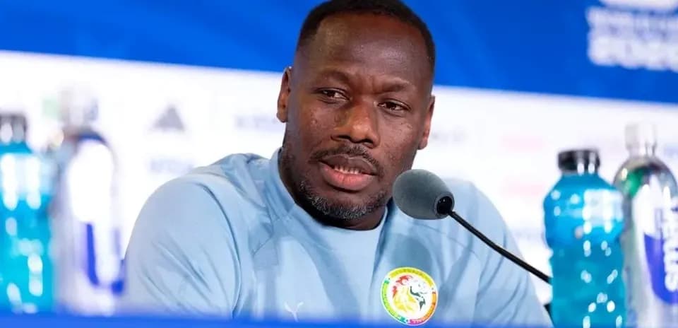 Manager speaking at press conference with microphones