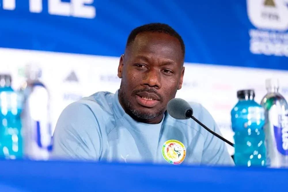 Manager speaking at press conference with microphones