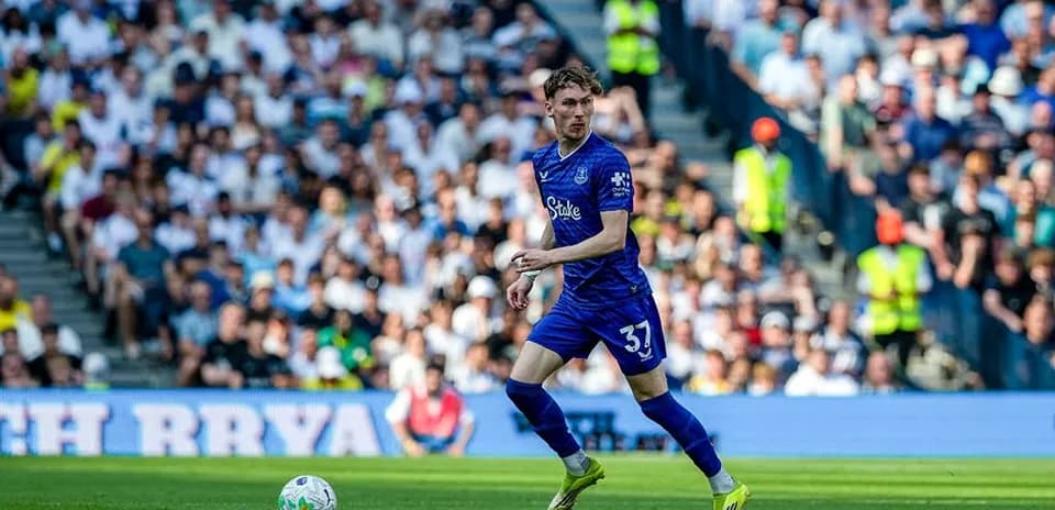 Player in blue kit running with the ball