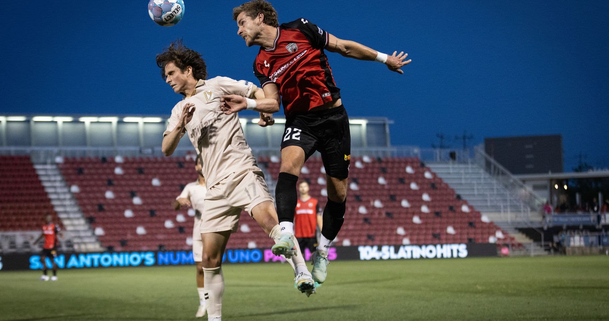 Players contesting for the ball during match