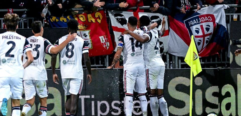 Cagliari players celebrating a goal with fans