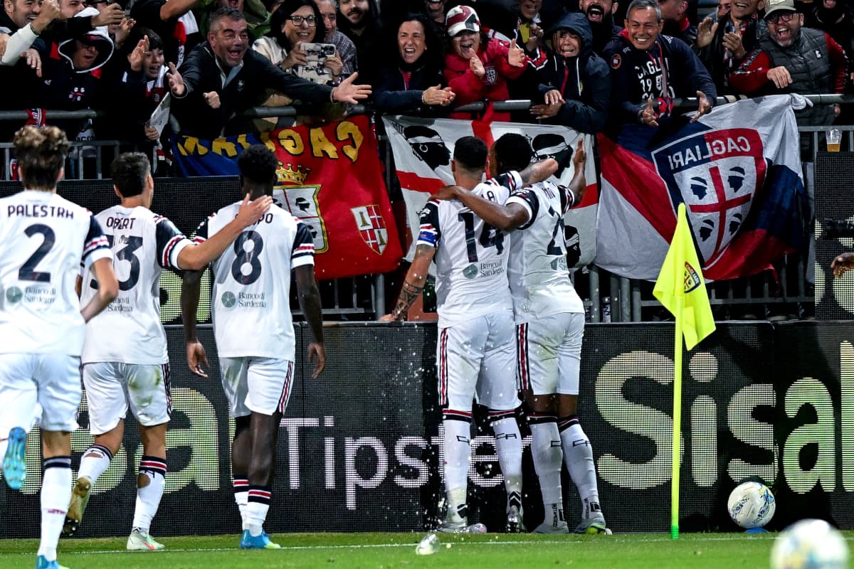 Cagliari players celebrating a goal with fans