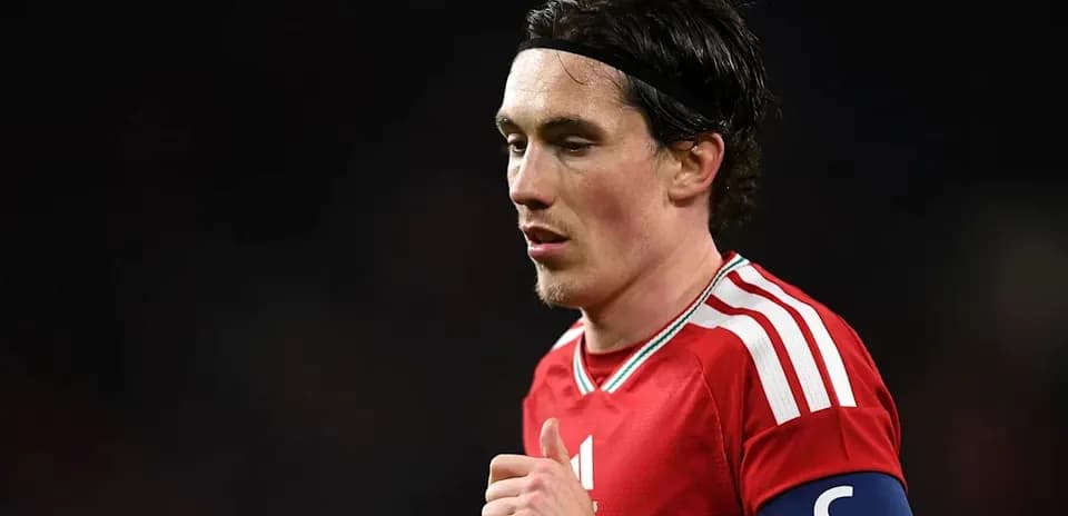 Player in red jersey with captain's armband during match