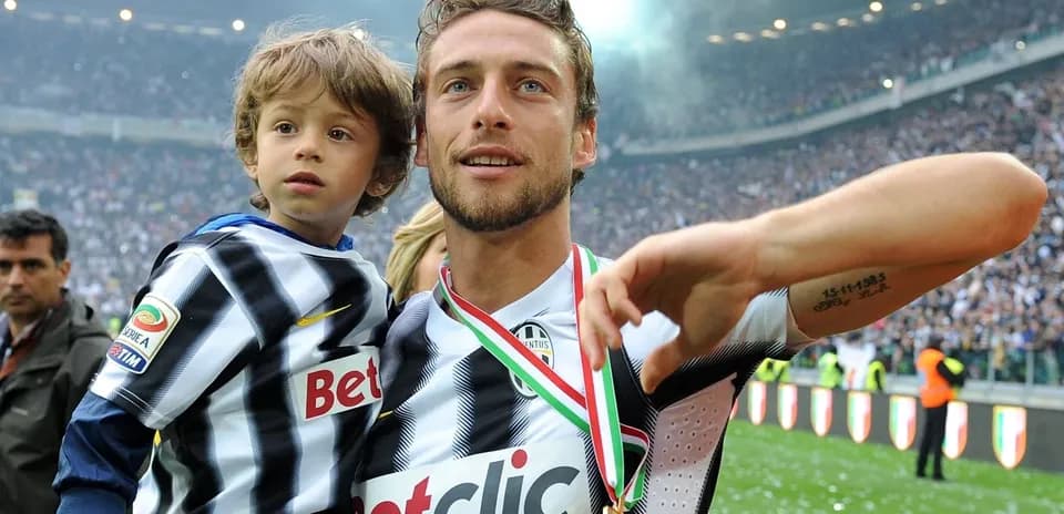 Player celebrating with child on the pitch