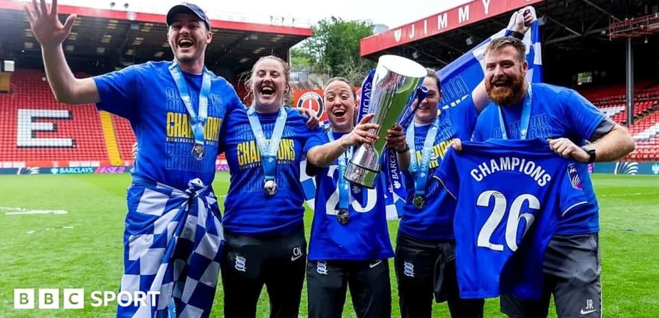 Celebrating team holding trophy and wearing medals