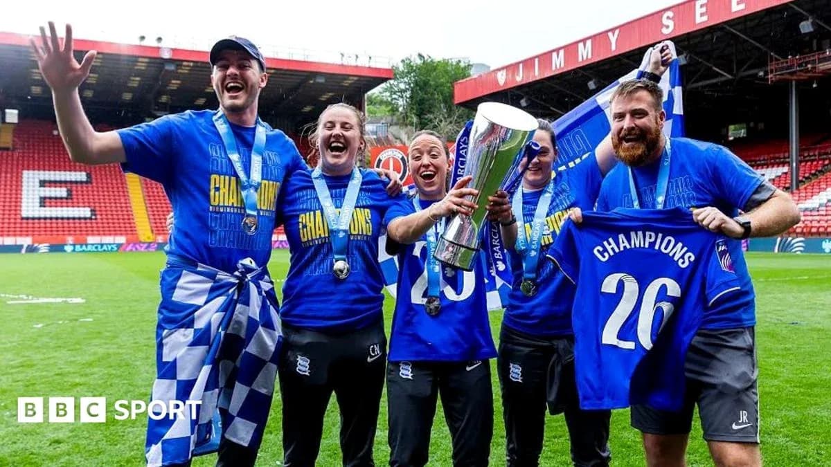 Celebrating team holding trophy and wearing medals