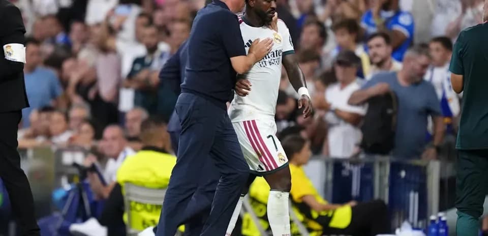 Coach embracing player during match substitution