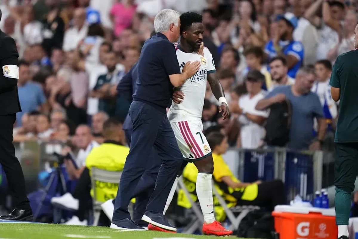 Coach embracing player during match substitution