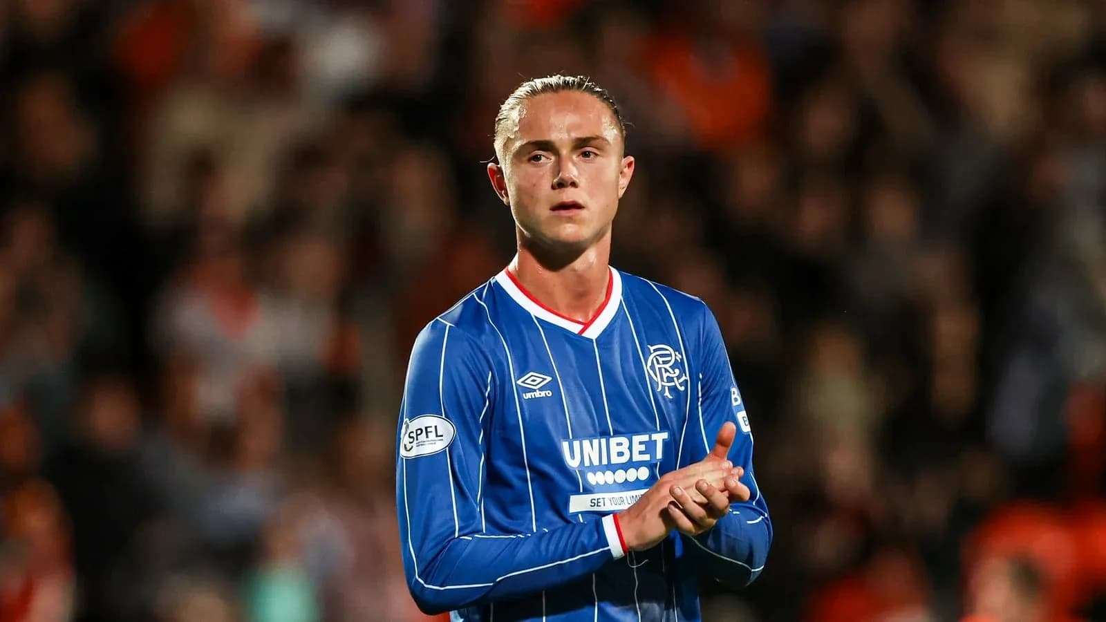 Player applauding fans during match at stadium