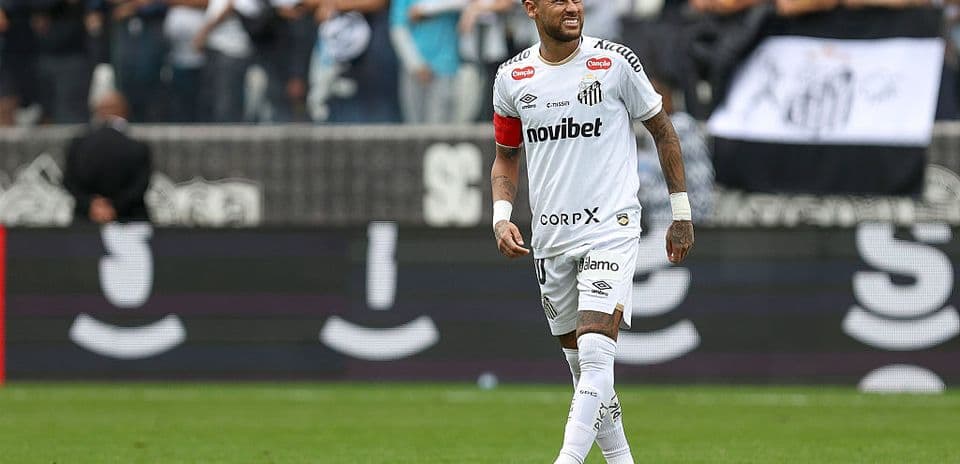 Player wearing white jersey celebrating in front of fans