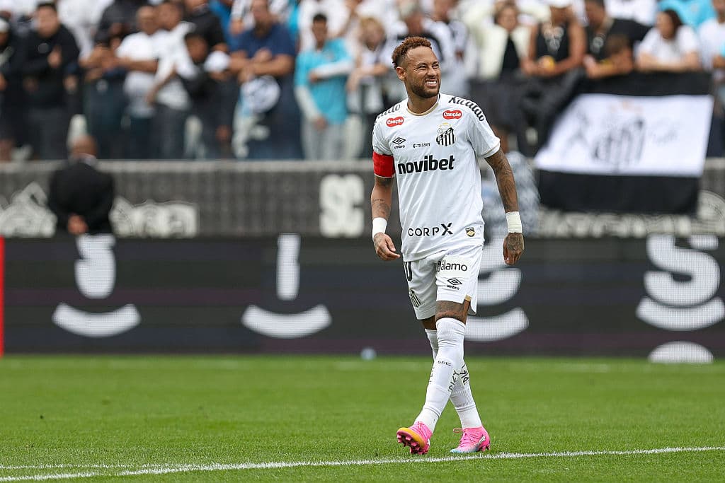 Player wearing white jersey celebrating in front of fans