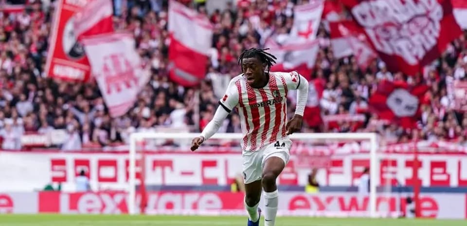 Player sprinting with ball amid cheering crowd
