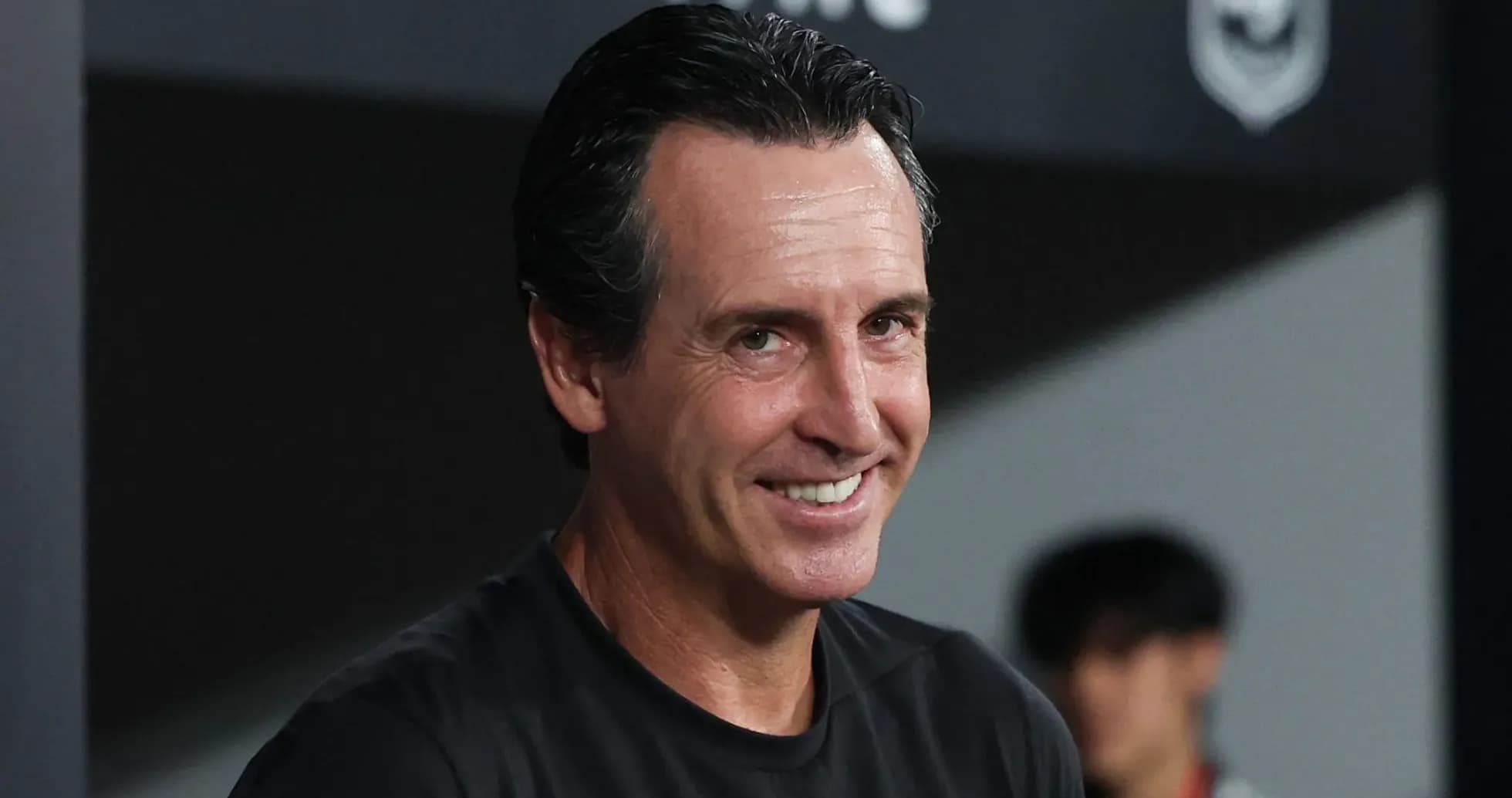 Coach smiling during match preparation on sideline