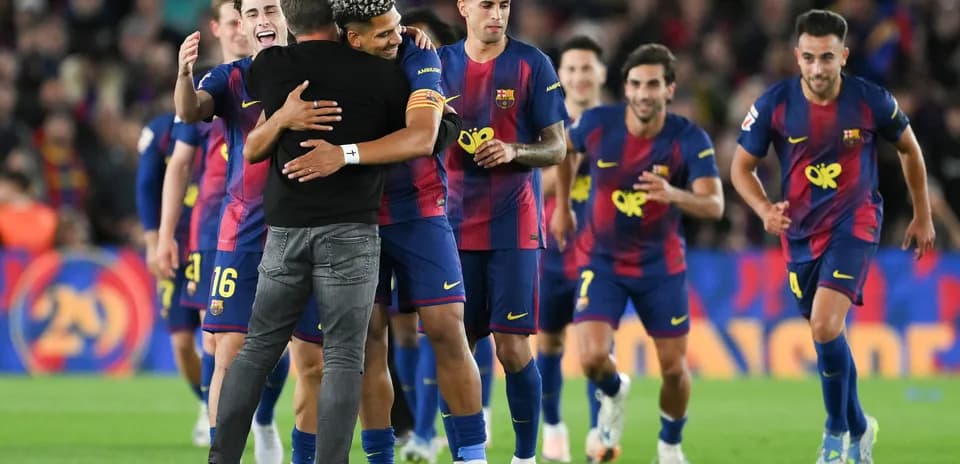 Barcelona players celebrating with coach after match