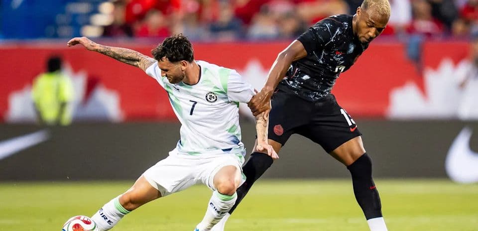 Two players battling for the ball during soccer match