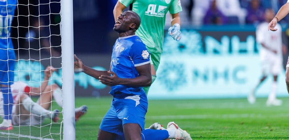 Player kneeling in front of goal after missed chance