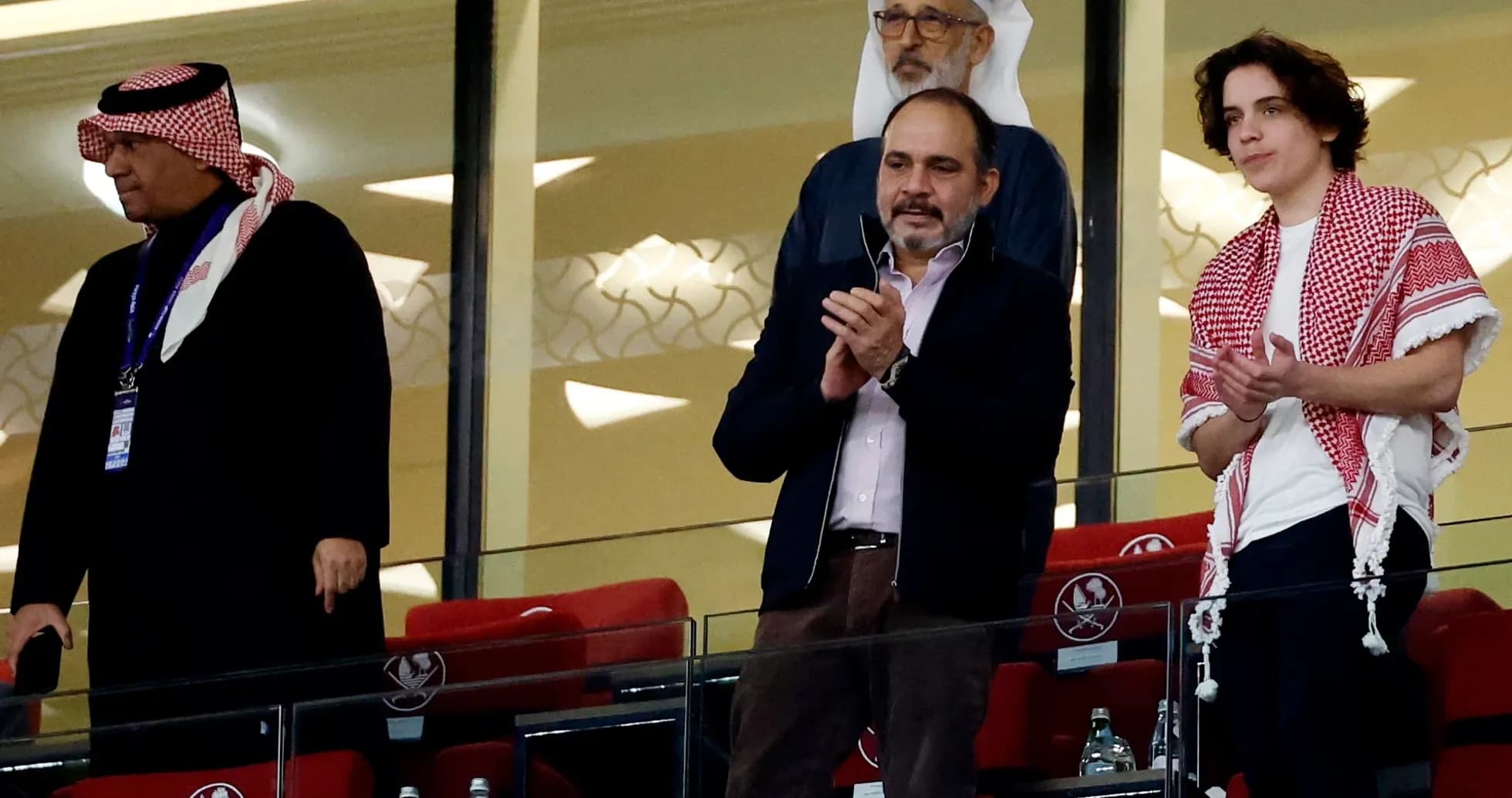 Spectators applauding in stadium viewing area