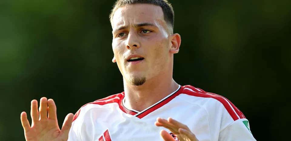 Player gesturing during training session in white jersey