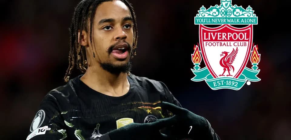 Player gesturing during match with Liverpool logo